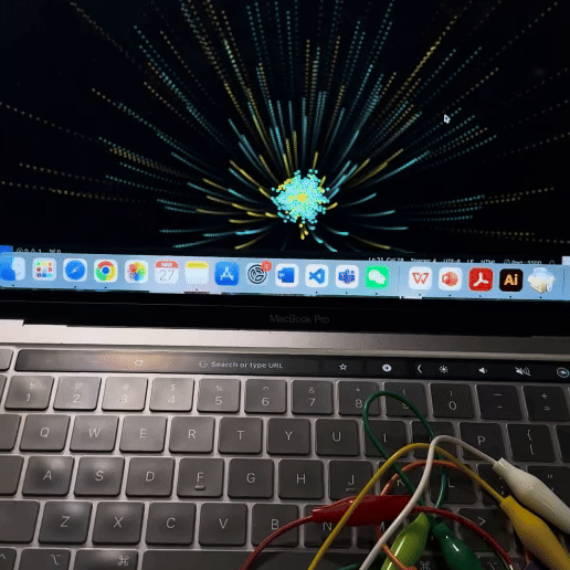 A colorful visual effect is displayed on a laptop screen, triggered by touches on the connected Makey Makey setup. This visual is an example of how interactive technology can create engaging and beautiful digital art in real-time.